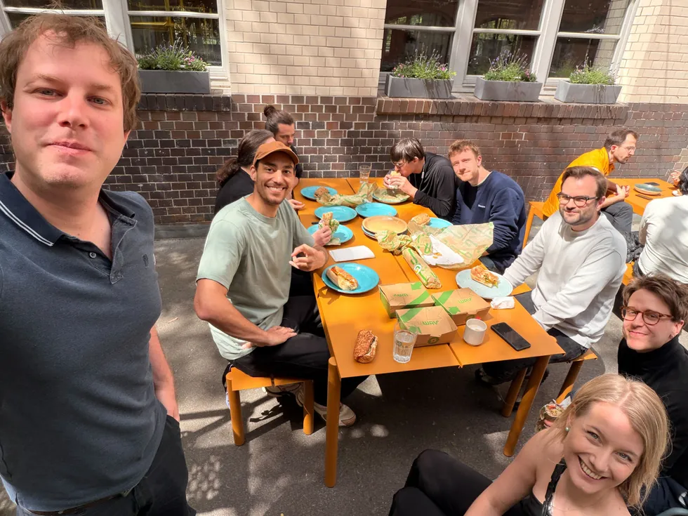 Node members sharing a meal outdoors