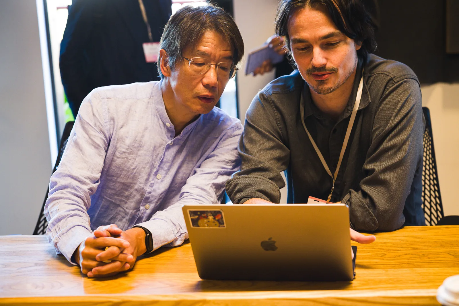 Two researchers looking at a laptop