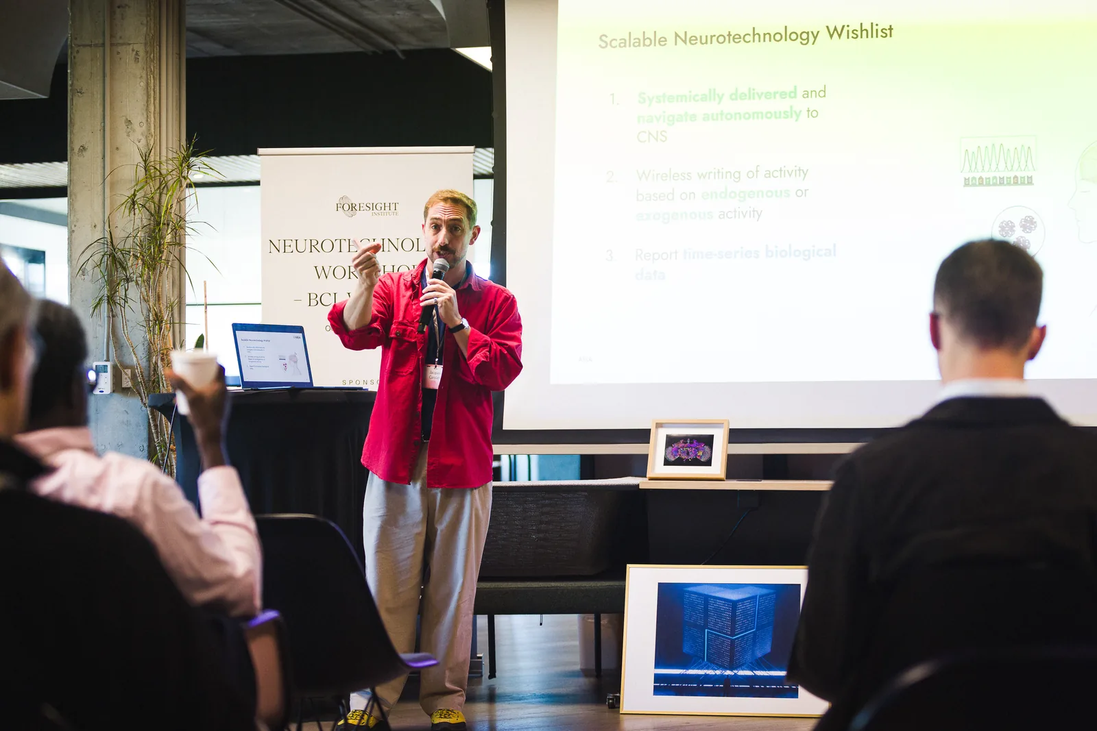 A presenter in front of slides