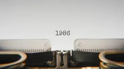 A typewriter with the year 1986 typed on paper