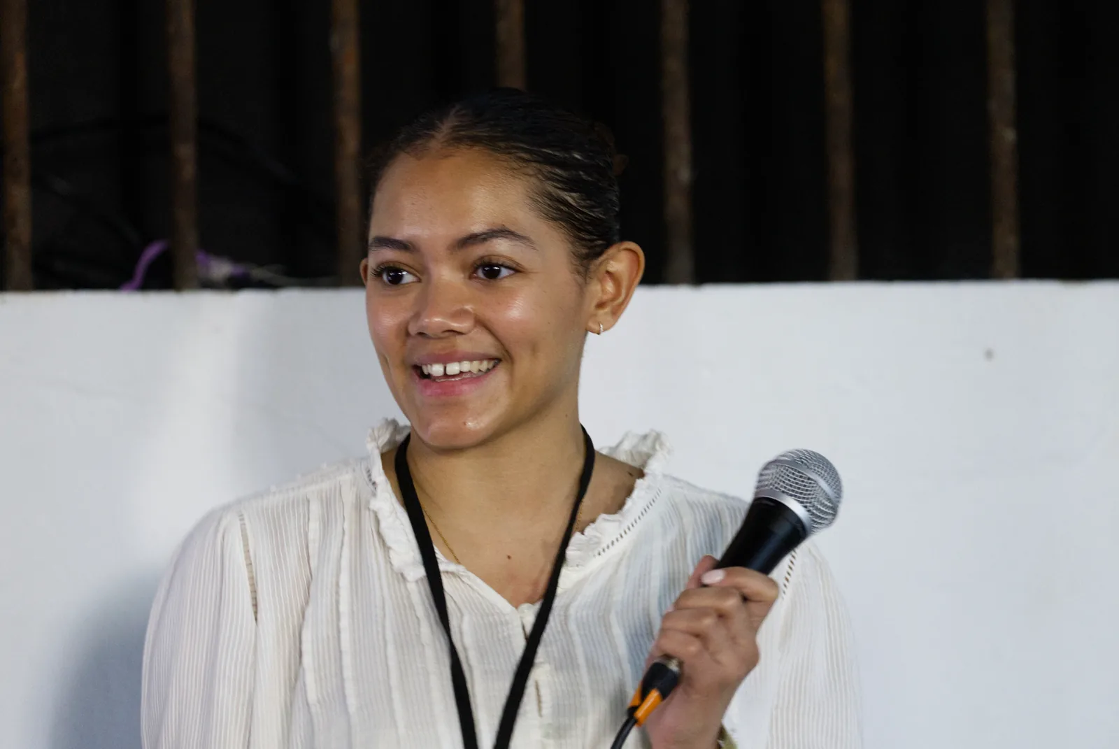 A speaker holding a microphone